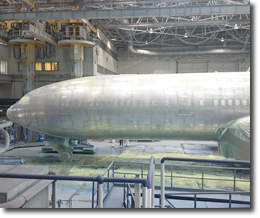 An aeroplane covered with dust sheets in the hangar