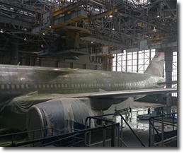 An aeroplane covered with dust sheets in the hangar